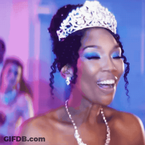 Woman In Tiara And Pearl Necklace Smiling GIF