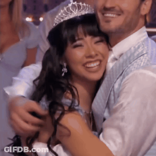 Woman In Tiara Hugged By Man GIF