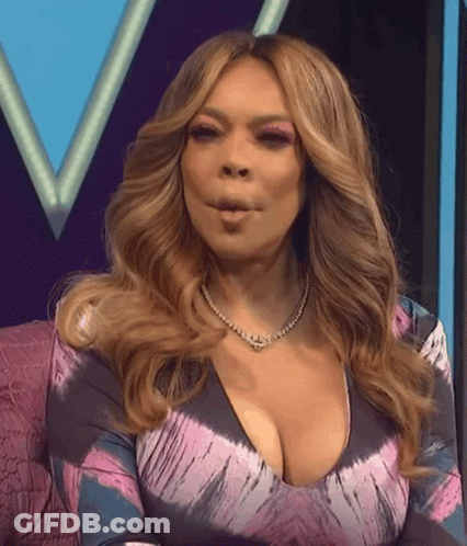 Woman In Tie Dye Dress Making Face GIF
