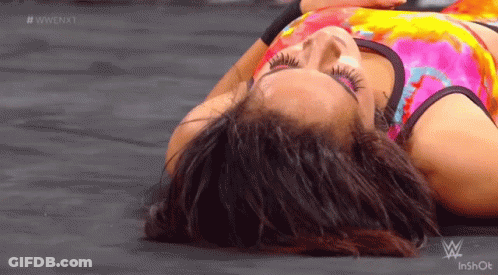 Woman In Tie Dye Shirt Lying With Eyes Closed GIF