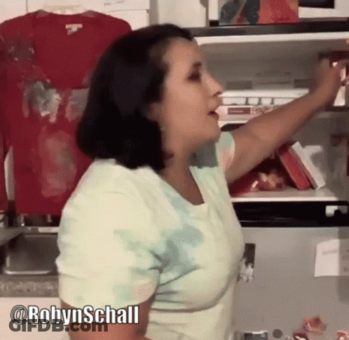 Woman In Tie Dye Shirt Reaching Into Fridge GIF