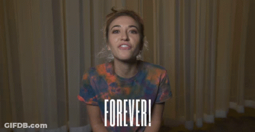 Woman In Tie-Dye Shirt With Forever Sign GIF