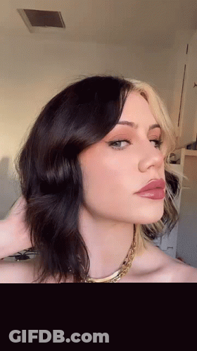 Woman In Tiger Print Top And Heart Necklace GIF