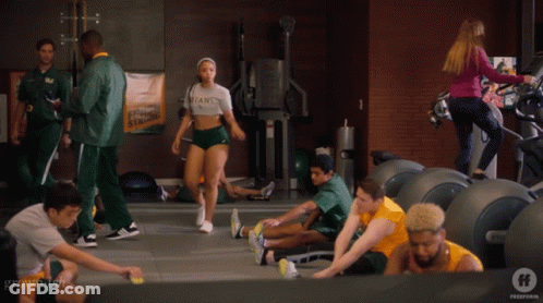 Woman In Titans Shirt In Gym GIF