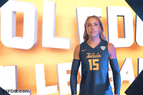 Woman In Toledo 15 Jersey In Front Of Sign GIF