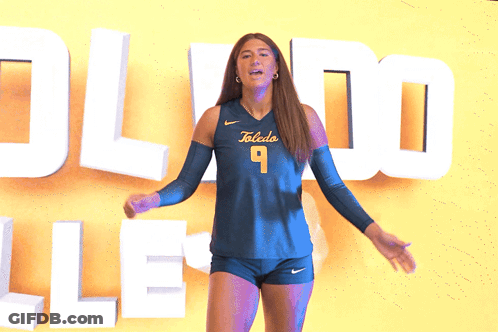 Woman In Toledo Jersey In Front Of Yellow Wall GIF