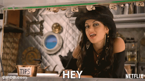 Woman In Top Hat Says Hey In Front Of Tips Sign GIF