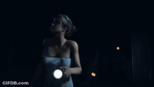 Woman In Towel Holding Flashlight In Dark GIF