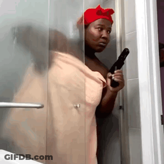 Woman In Towel Holding Gun In Shower GIF