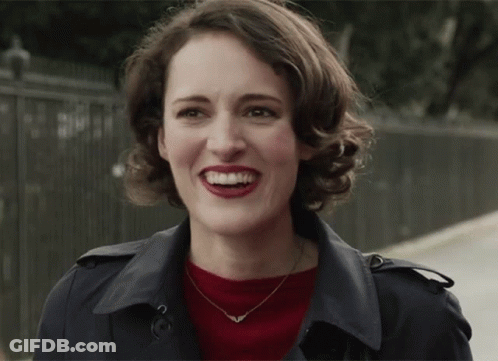 Woman In Trench Coat And Red Lipstick Smiling GIF