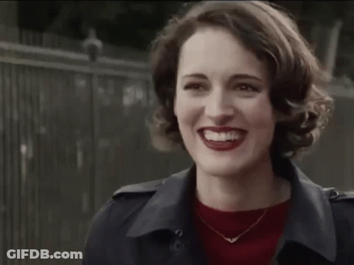 Woman In Trench Coat And Red Sweater Smiling GIF
