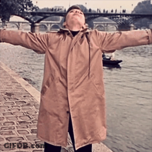 Woman In Trench Coat By River GIF