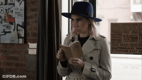 Woman In Trench Coat Reading Field Notes GIF