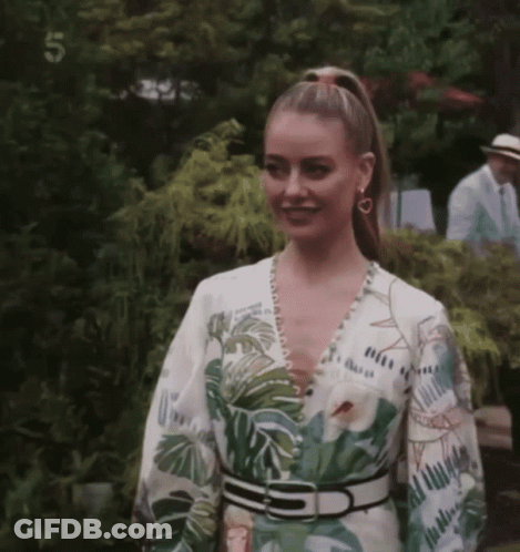 Woman In Tropical Print Dress With Number 5 GIF