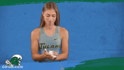 Woman In Tulane Tank Top Holding Something GIF