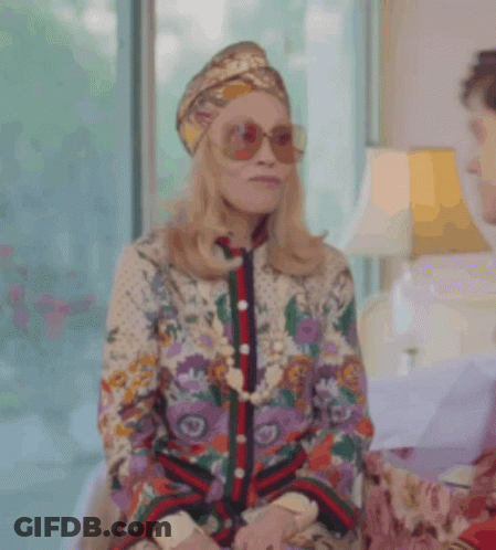 Woman In Turban And Sunglasses Next To Man GIF