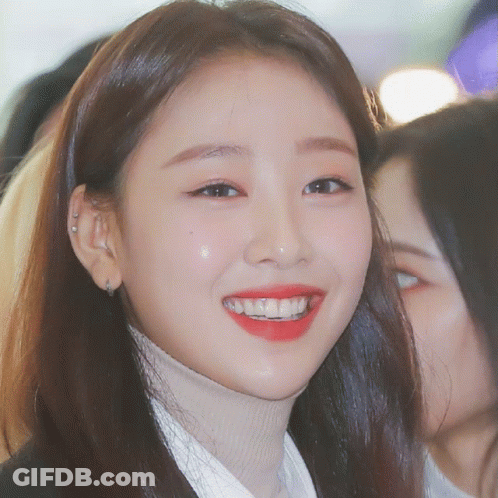 Woman In Turtleneck And Red Lipstick Smiling GIF