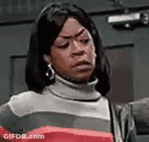 Woman In Turtleneck Making Funny Face GIF