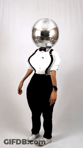 Woman In Tuxedo And Suspenders With Disco Ball On Head GIF