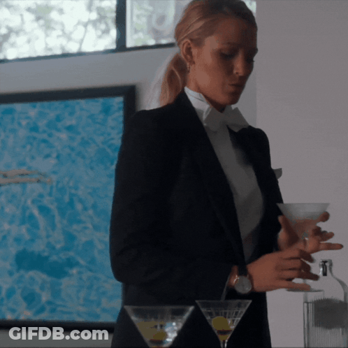 Woman In Tuxedo Holding Martini GIF