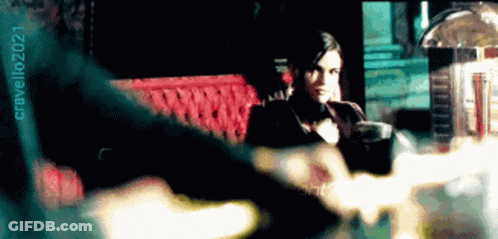 Woman In Tuxedo Sitting On Red Couch 2021 GIF