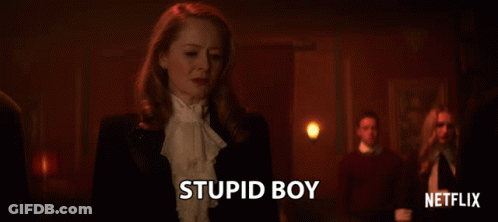 Woman In Tuxedo Stands In Front Of Netflix Logo GIF