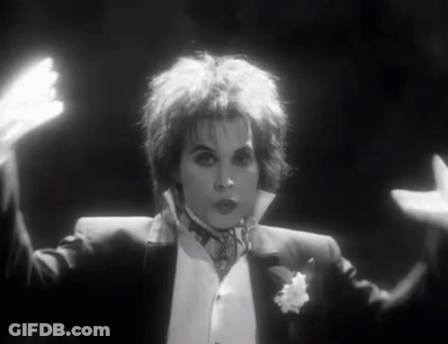 Woman In Tuxedo With Outstretched Hands GIF