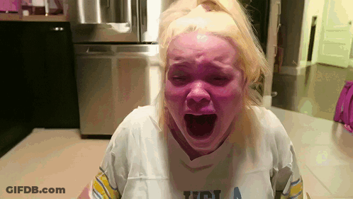 Woman In UCLA Shirt Screaming With Mouth Open GIF