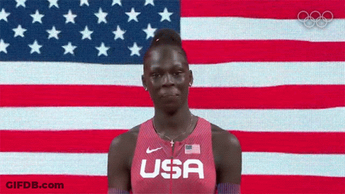 Woman In USA Shirt Before American Flag GIF