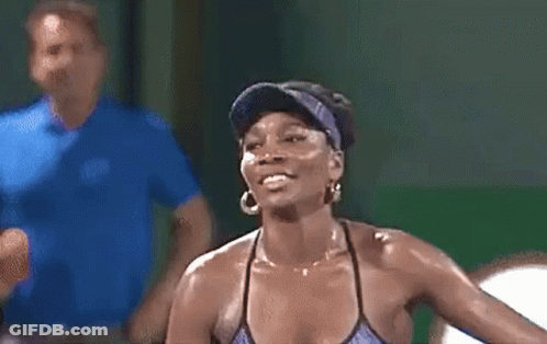 Woman In Visor And Earrings Smiling With Man Behind Her GIF