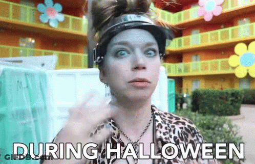 Woman In Visor And Leopard Print Shirt Says During Halloween GIF