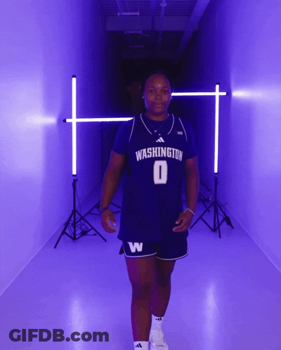 Woman In Washington Jersey Walking In Purple Hallway GIF
