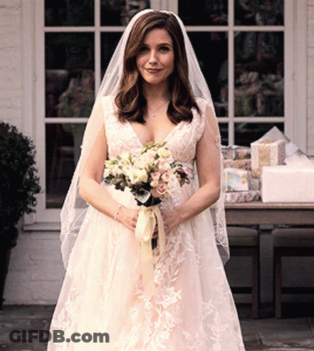 Woman In Wedding Dress Holding Bouquet GIF