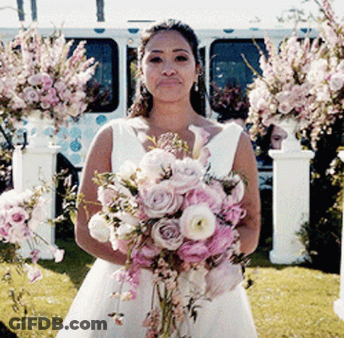 Woman In Wedding Dress Holding Pink Bouquet GIF