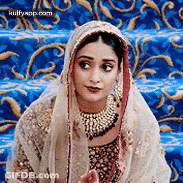 Woman In Wedding Dress Sitting On Blue Carpet GIF