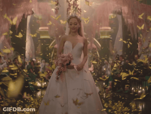 Woman In Wedding Dress Surrounded By Butterflies And Flowers GIF