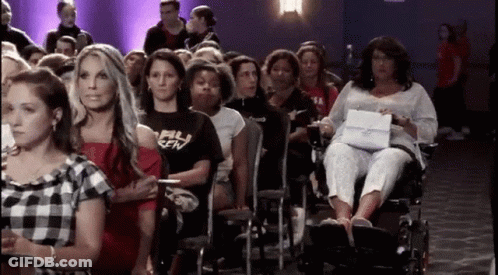 Woman In Wheelchair In Crowd GIF