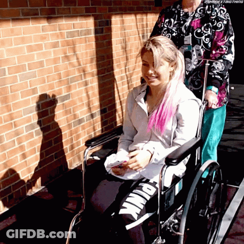 Woman In Wheelchair Pushed By Another Woman GIF