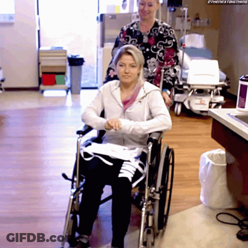 Woman In Wheelchair Pushed By Nurse Saying The Next Thing GIF