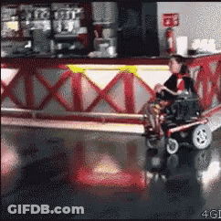 Woman In Wheelchair Riding Scooter In Restaurant GIF