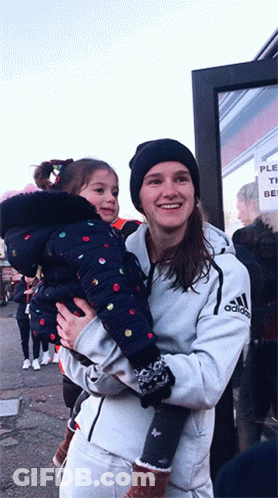 Woman In White Adidas Jacket Holding Girl GIF