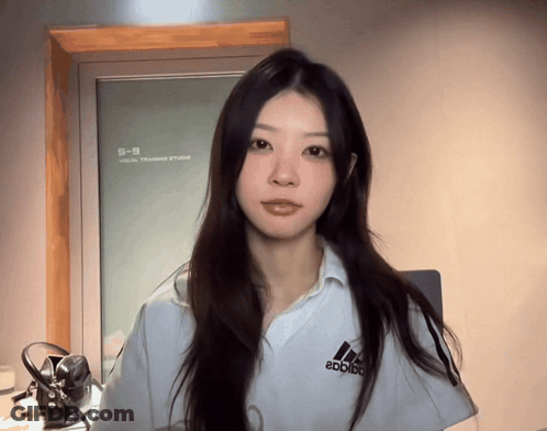 Woman In White Adidas Shirt In Front Of Mirror GIF