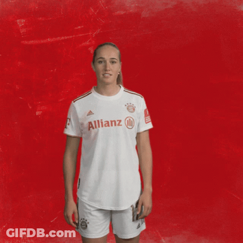 Woman In White Allianz Shirt At Red Wall GIF