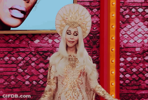 Woman In White And Gold Costume Pink Wall GIF