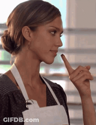 Woman In White Apron Holding Finger To Lips GIF