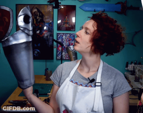 Woman In White Apron Holding Silver Object GIF
