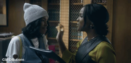Woman In White Beanie Talking To Another Woman GIF