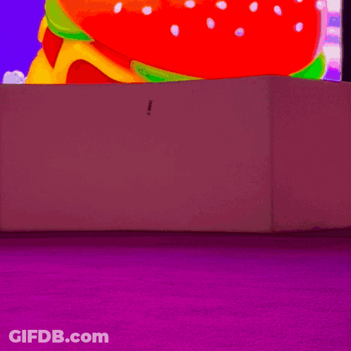 Woman In White Boots In Front Of Colorful Screen GIF