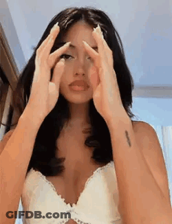 Woman In White Bra Covering Face With Hands GIF