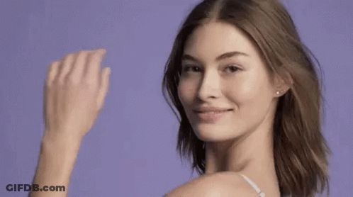 Woman In White Bra Waving And Smiling GIF